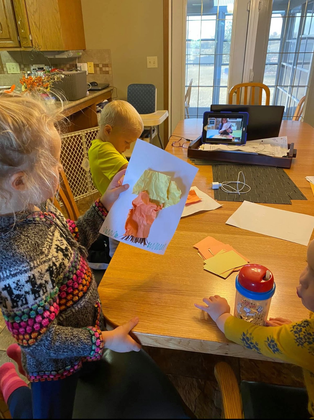 Children doing a craft activity while watching Busy Bees class on tablet