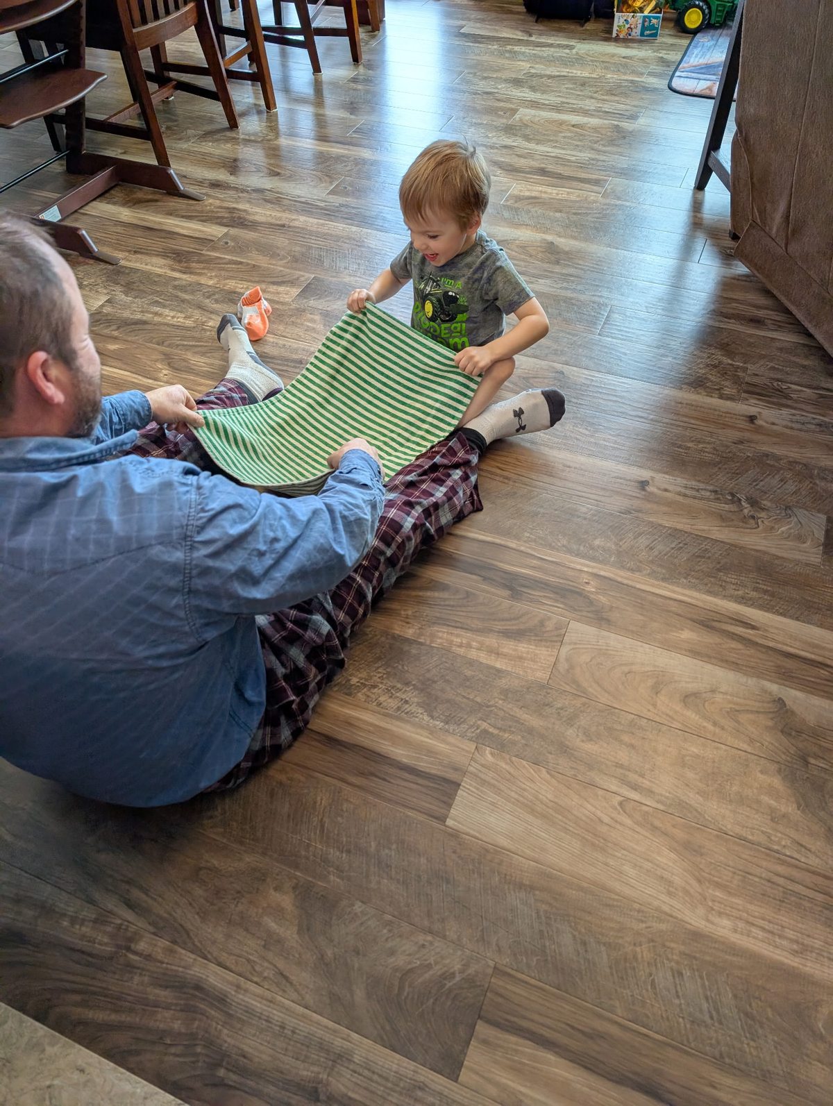 Dad and toddler playing with letter tiles during Busy Bees activity