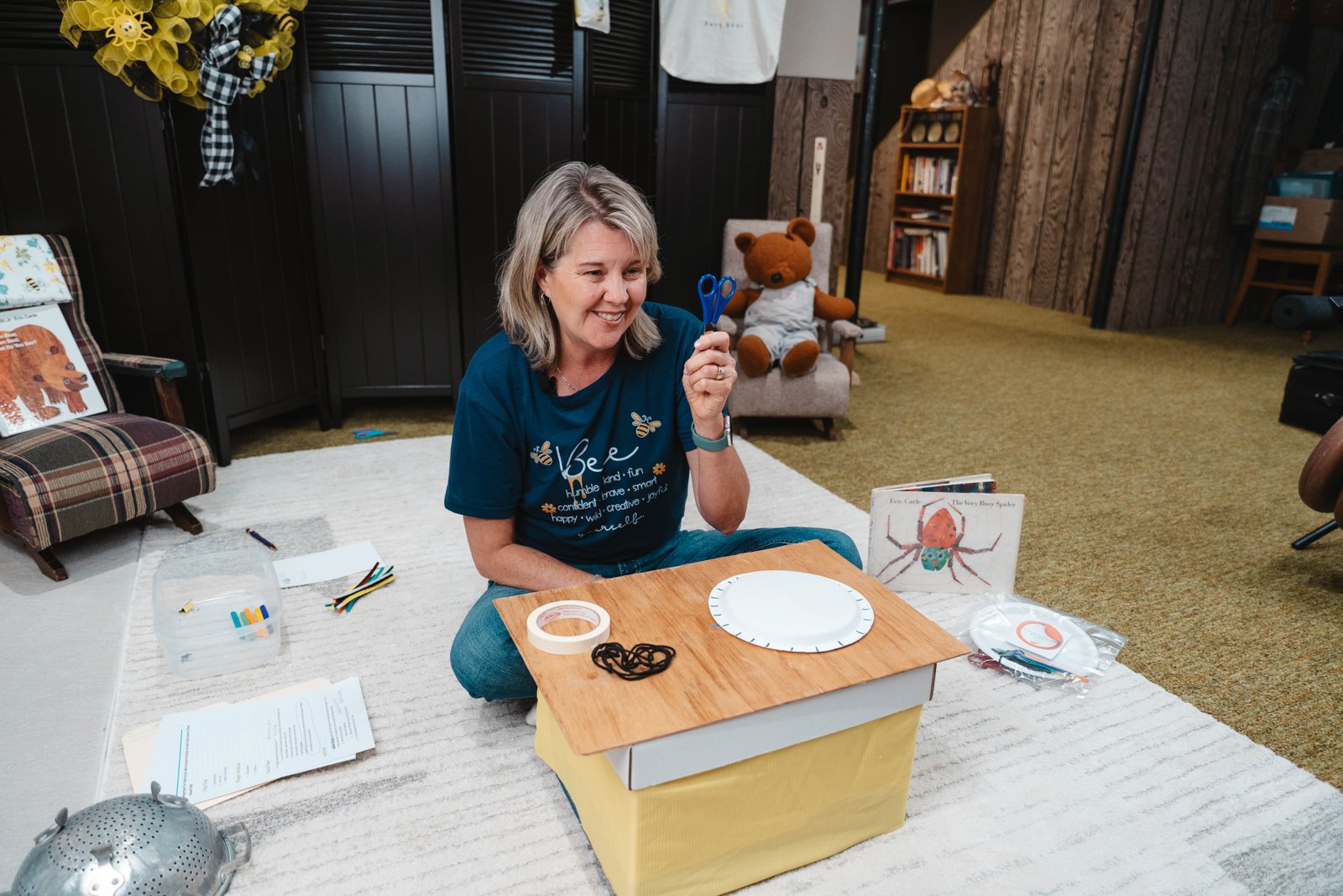 Joanne McMahon holding scissors, preparing a Pre-Scissor Skills activity